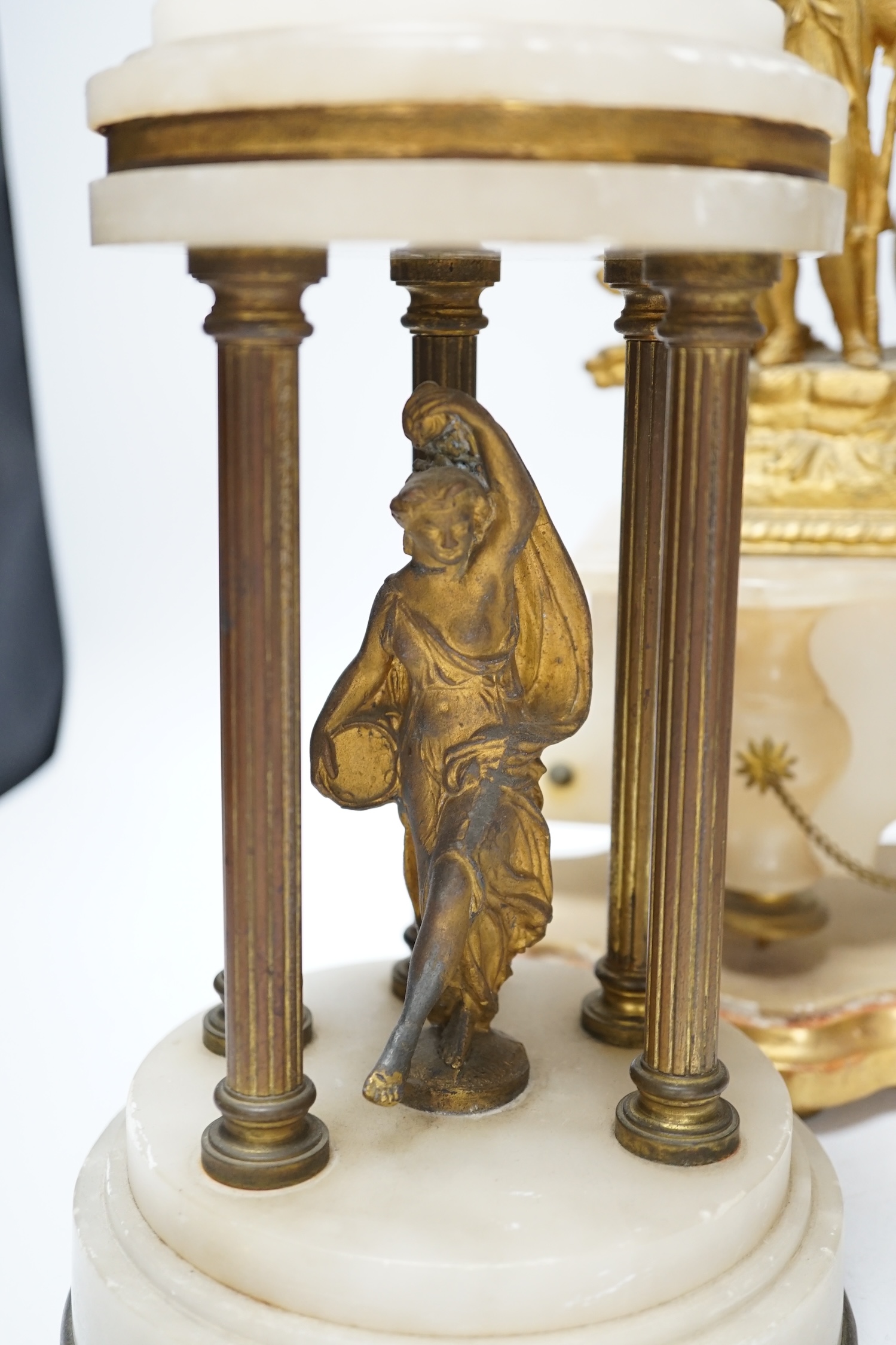 A French spelter and alabaster figural clock garniture, clock 23cm high